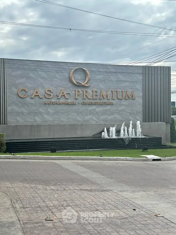 Elegant entrance of Casa Premium with modern design and water feature, showcasing luxury living.
