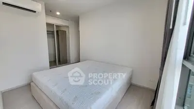 Spacious bedroom with large bed and mirrored closet in modern apartment