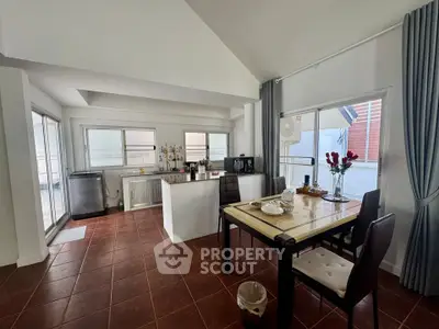 Spacious kitchen with dining area and modern appliances in a bright, open layout.