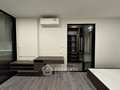 Modern bedroom with walk-in closet and sleek air conditioning unit