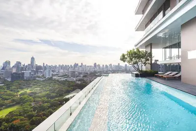 Luxurious rooftop pool with stunning city skyline view, perfect for urban living enthusiasts.