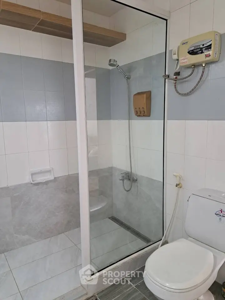 Modern bathroom with glass shower enclosure and water heater