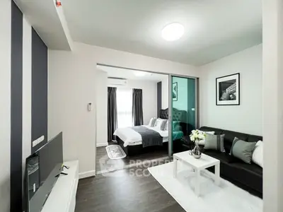 Modern living room with sleek decor and cozy bedroom view