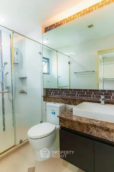 Modern bathroom with glass shower and marble countertop