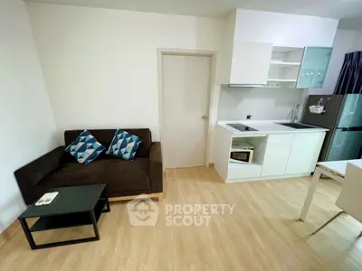 Modern apartment interior with cozy living area and compact kitchen