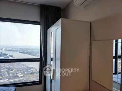 Modern bedroom with wardrobe and stunning city view from large window