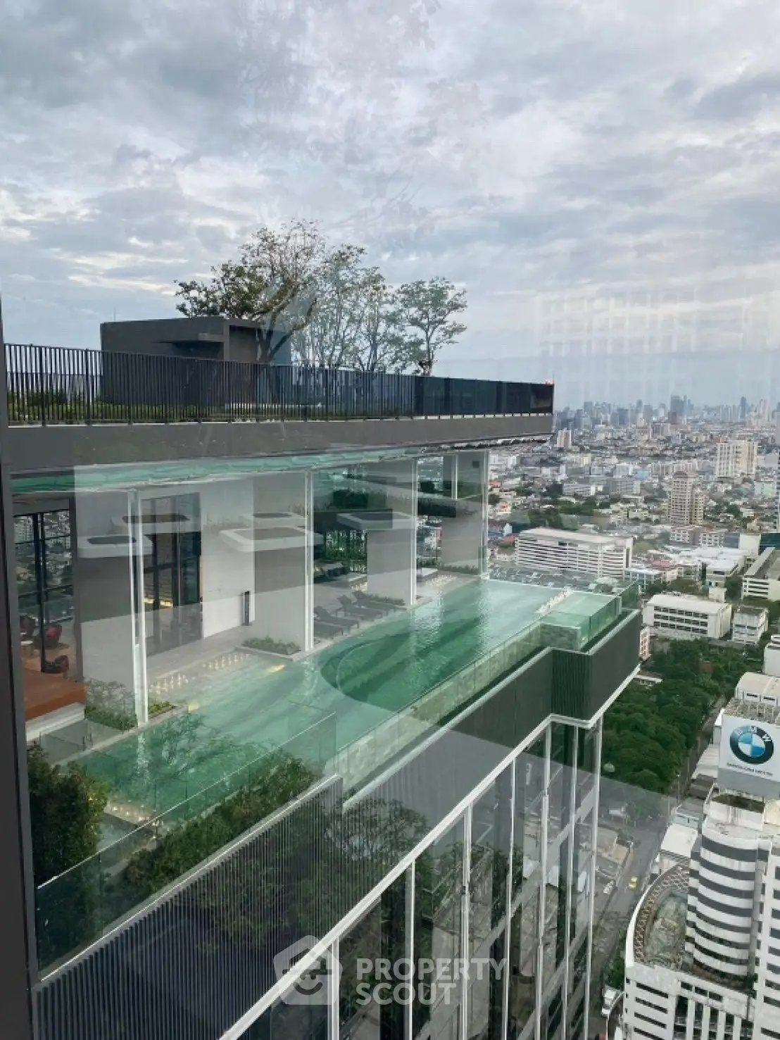 Stunning rooftop pool with panoramic city views in a modern high-rise building.