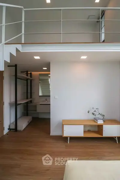 Modern loft-style living room with mezzanine and sleek wooden flooring