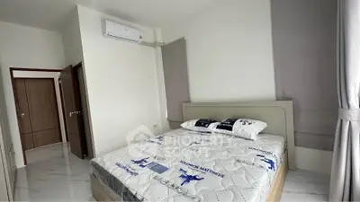 Modern bedroom with air conditioning and stylish decor in a contemporary apartment.