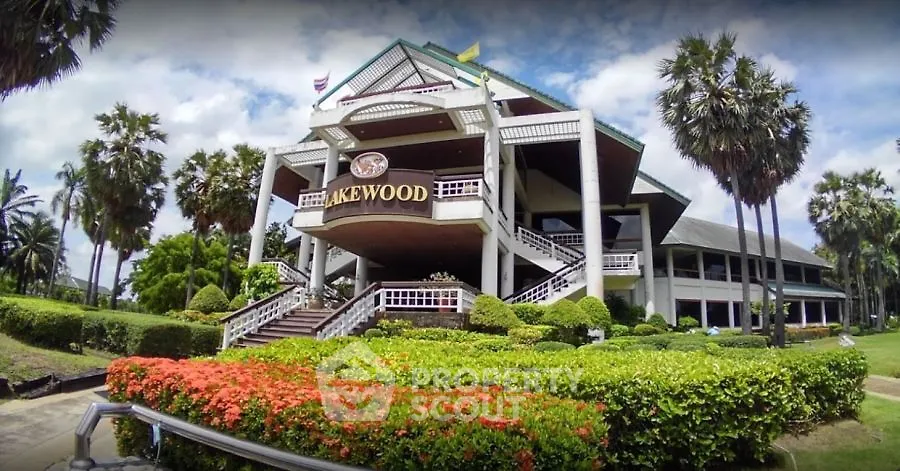 Stunning exterior view of a luxurious building surrounded by lush greenery and palm trees.
