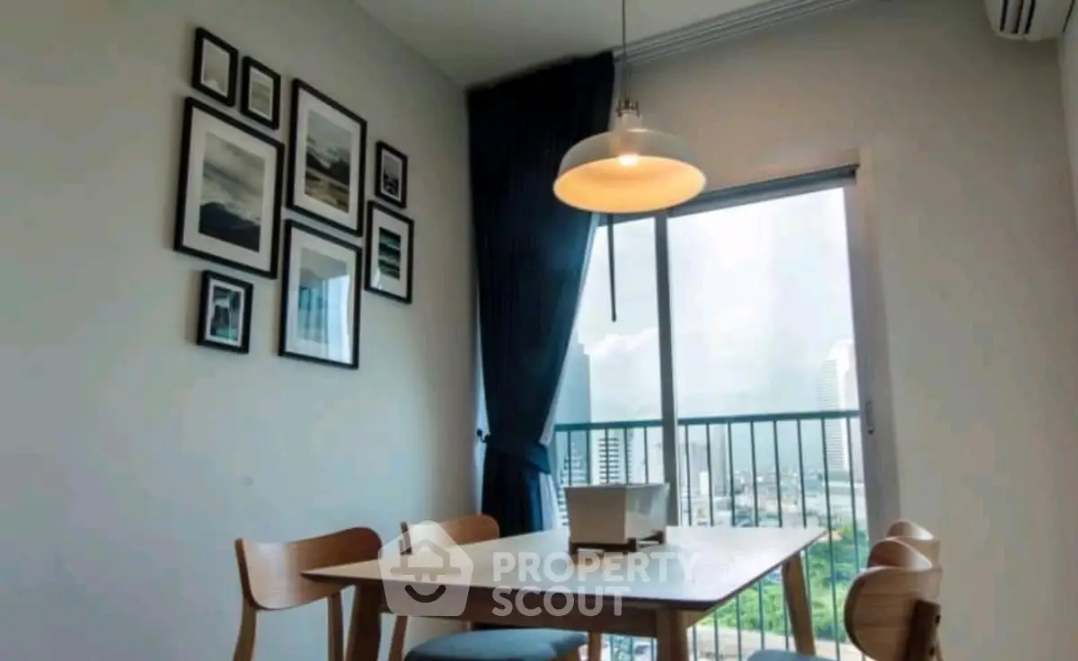 Modern dining area with natural light and city view, featuring stylish decor and elegant furniture.