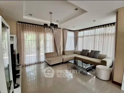 Elegant living room with modern furniture and large windows for natural light.