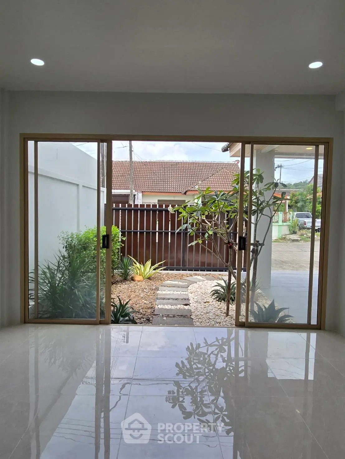 Spacious modern entrance with sliding glass doors and garden view