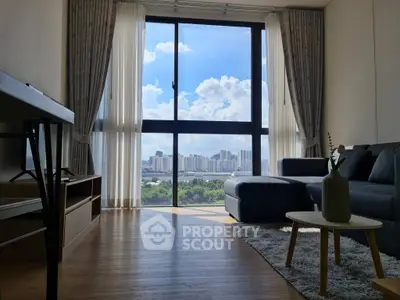 Modern living room with large window offering stunning city view, cozy seating, and elegant decor.