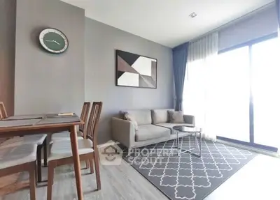 Modern living room with stylish decor and natural light in a contemporary apartment.