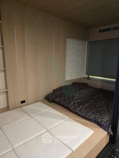 Modern bedroom with stylish wood paneling and cozy bedding