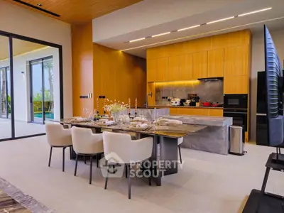 Luxurious modern kitchen with open layout and elegant dining area, featuring sleek cabinetry and stylish decor.