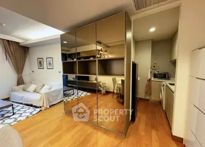 Modern living room with mirrored wardrobe and cozy seating area