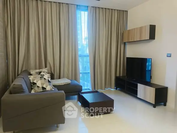 Modern living room with sleek furniture and large window