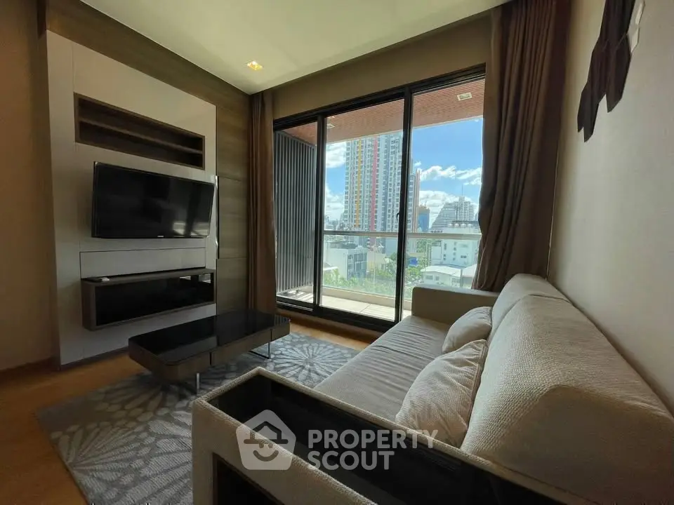 Modern living room with large window and city view, featuring a sleek TV setup and comfortable sofa.
