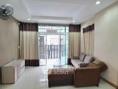 Spacious living room with modern sofa and large windows for natural light