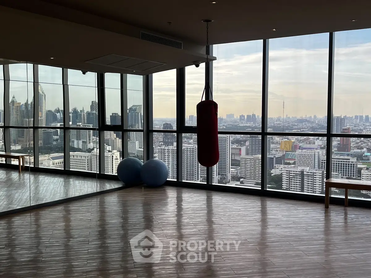 Stunning gym with panoramic city view and modern equipment