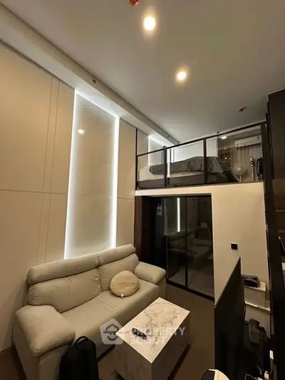 Modern loft apartment with cozy living area and elevated bedroom
