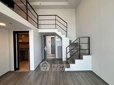 Modern duplex interior with sleek staircase and open layout