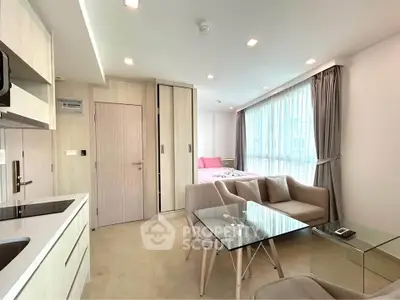 Modern open-plan studio apartment with stylish furniture and large windows
