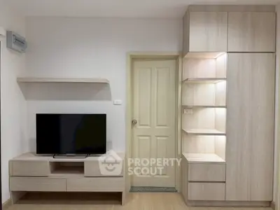 Modern living room with sleek wooden furniture and flat-screen TV, perfect for cozy relaxation.