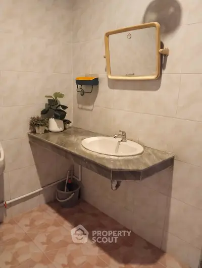 Charming bathroom with elegant sink and stylish mirror, perfect for modern living.