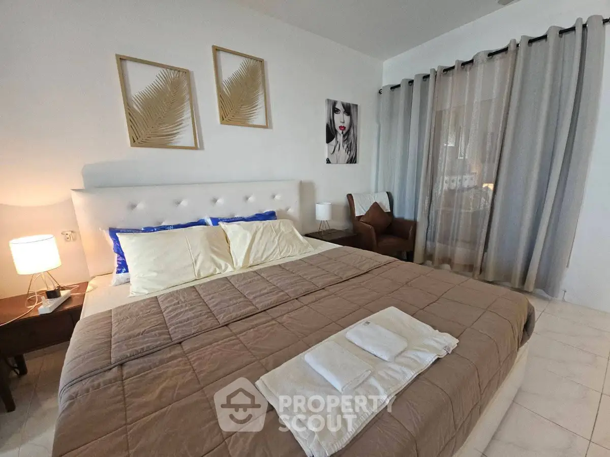 Cozy bedroom with elegant decor and large bed in modern real estate property.