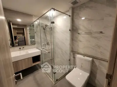 Modern bathroom with glass shower and sleek fixtures in luxury apartment