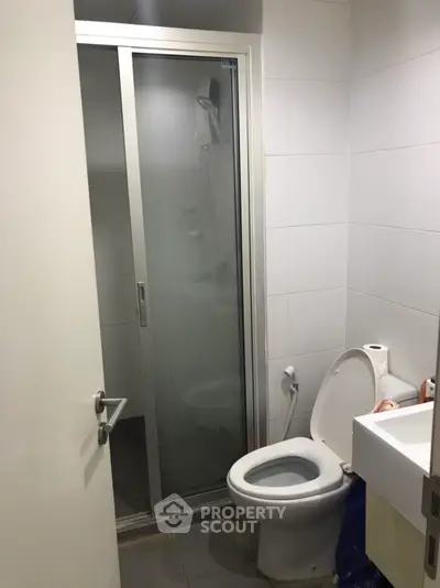 Compact bathroom with shower and toilet in modern apartment