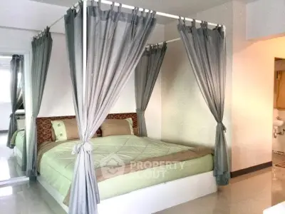 Elegant bedroom with canopy bed and soft lighting, perfect for relaxation.