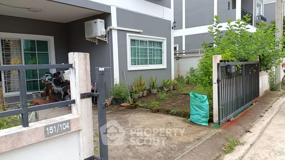 Charming townhouse with small garden and gated entrance, perfect for cozy living.
