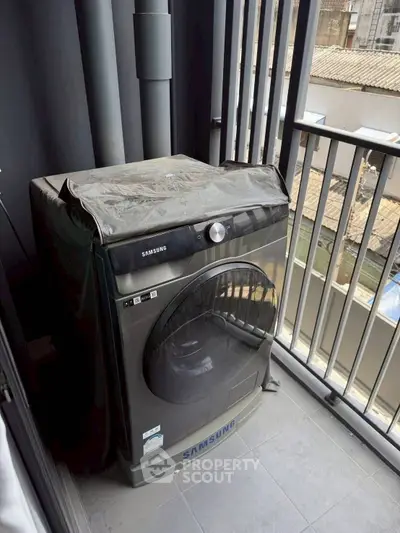 Modern balcony with Samsung washing machine and urban view.