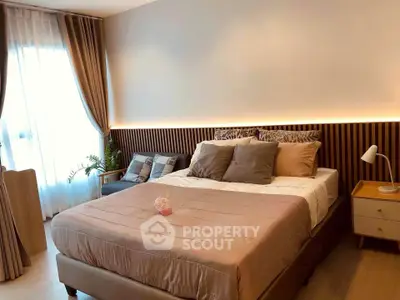 Elegant bedroom with modern decor and cozy lighting, featuring a comfortable bed and stylish furnishings.