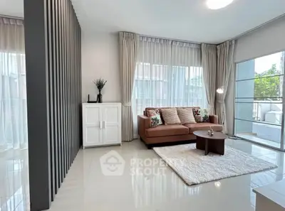 Stylish living room with modern decor and large windows offering natural light.