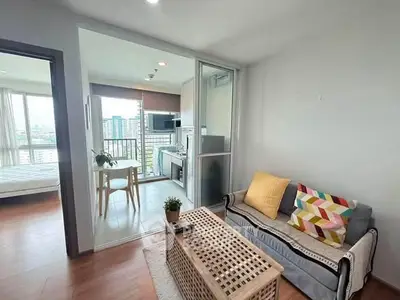 Modern condo living room with open layout and city view, featuring cozy sofa and dining area.