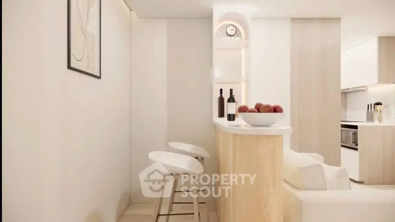 Modern minimalist kitchen with breakfast bar and stylish stools in a bright open layout.