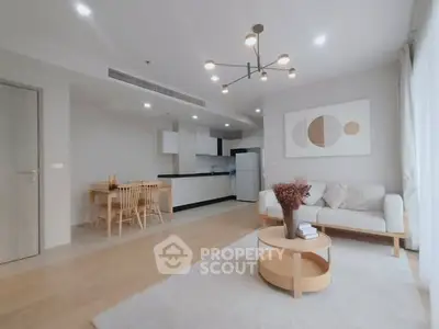 Modern open-plan living room with stylish decor and natural light