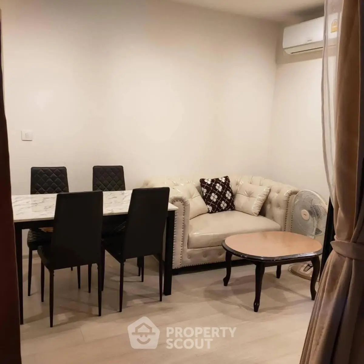 Cozy living room with elegant dining area and plush sofa, perfect for modern living.