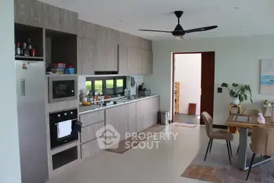 Modern kitchen with sleek cabinetry and dining area in open layout