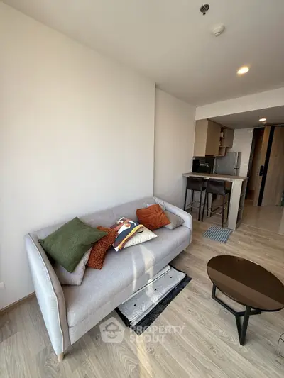 Modern living room with cozy sofa and stylish decor in open layout apartment.