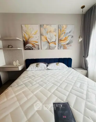 Elegant bedroom with modern decor and stylish artwork above a plush bed, perfect for relaxation.