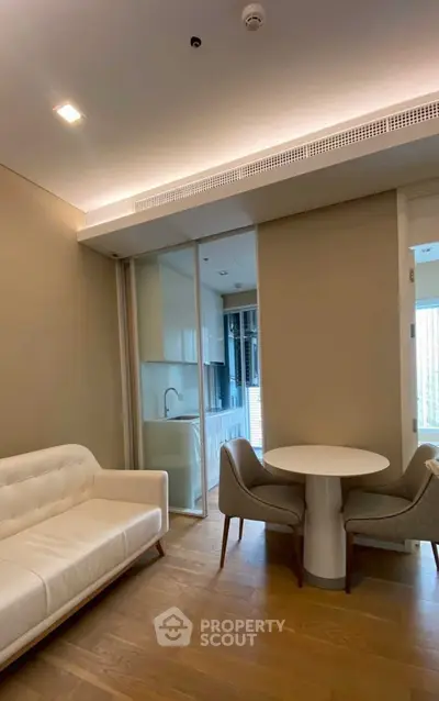 Modern living room with cozy seating and open kitchen layout