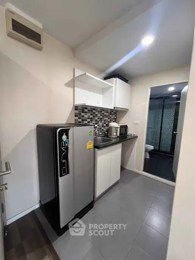 Modern compact kitchen with sleek appliances and stylish backsplash