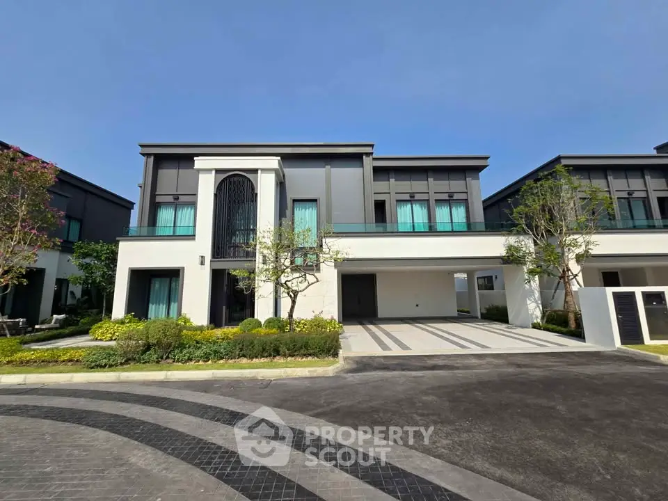 Modern two-story house with sleek design and spacious driveway