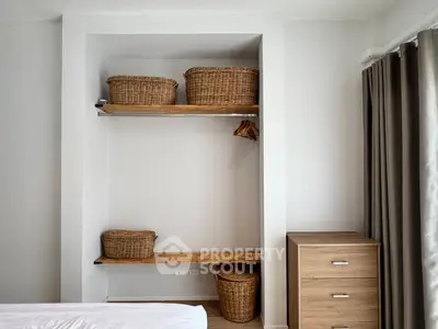 Cozy bedroom with built-in storage and wicker baskets, perfect for organized living.